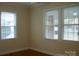 Bedroom with hardwood floors and two large windows with blinds at 518 Oak St, Troy, NC 27371