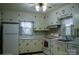 Charming kitchen with white cabinets, and a window at 518 Oak St, Troy, NC 27371