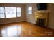 Living room with hardwood floors, fireplace and large windows at 518 Oak St, Troy, NC 27371