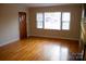 Bright living room with hardwood floors and large windows at 518 Oak St, Troy, NC 27371