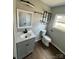 Bathroom with a modern sink, toilet, decorative mirror and shelving at 552 6Th St, Chester, SC 29706