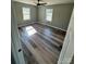 Bedroom with wood floors, neutral walls, two windows, and a ceiling fan at 552 6Th St, Chester, SC 29706