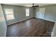 Cozy bedroom featuring wood floors, neutral walls, windows, and a door at 552 6Th St, Chester, SC 29706