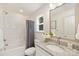 This is a well-lit bathroom featuring a large vanity with granite top and a tiled shower at 5812 Torrence St, Charlotte, NC 28269