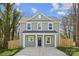 Two-story home featuring light green siding, a dark front door, a concrete driveway, and a well-manicured lawn at 5812 Torrence St, Charlotte, NC 28269