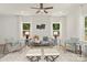 Cozy living room with neutral-toned furniture, a ceiling fan, bright windows, and a plush rug at 5812 Torrence St, Charlotte, NC 28269