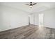 Spacious bedroom featuring wood-look floors and access to a bathroom at 6518 Afterglow Dr, Indian Trail, NC 28079