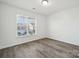 Well-lit bedroom with wood-look floors and a window at 6518 Afterglow Dr, Indian Trail, NC 28079