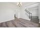 Dining room with chandelier, laminate floors, and view of kitchen and stairs at 6518 Afterglow Dr, Indian Trail, NC 28079