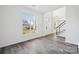 Spacious foyer with grey flooring and view into living room and stairs at 6518 Afterglow Dr, Indian Trail, NC 28079