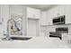 Modern kitchen with white cabinets, stainless steel appliances, and island at 6518 Afterglow Dr, Indian Trail, NC 28079