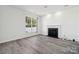 Living room with fireplace and laminate wood flooring at 6518 Afterglow Dr, Indian Trail, NC 28079