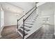 Elegant staircase with dark wood and white railings at 6518 Afterglow Dr, Indian Trail, NC 28079