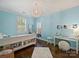 Bright bedroom with light blue walls and built-in shelving at 6819 Conservatory Ln, Charlotte, NC 28210