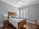 Charming bedroom with hardwood floors and a classic wooden bed frame at 6819 Conservatory Ln, Charlotte, NC 28210