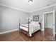 Spacious bedroom with hardwood floors and a large four-poster bed at 6819 Conservatory Ln, Charlotte, NC 28210