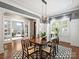 Elegant dining room with chandelier, hardwood floors, and built-in cabinetry at 6819 Conservatory Ln, Charlotte, NC 28210