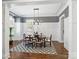 Elegant dining room with chandelier, hardwood floors, and built-in cabinetry at 6819 Conservatory Ln, Charlotte, NC 28210