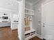 Welcoming entryway with custom built-ins for organization and storage, complemented by hardwood floors and neutral decor at 6819 Conservatory Ln, Charlotte, NC 28210