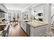 Modern kitchen with island, white cabinets, and stainless steel appliances at 6819 Conservatory Ln, Charlotte, NC 28210