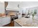 Modern kitchen with white cabinets, marble countertops, and high-end appliances at 6819 Conservatory Ln, Charlotte, NC 28210