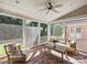 Screened porch with brick floor, ceiling fan, and comfy seating at 6819 Conservatory Ln, Charlotte, NC 28210