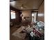 Cluttered living room with wood paneling and a ceiling fan at 6862 Royal Heights Cir, Hickory, NC 28602