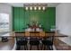 Farmhouse dining room with green accent wall and wooden table at 748 Inwood Hill Dr, Gastonia, NC 28056