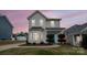 Two-story white house with landscaping and American flag at dusk at 748 Inwood Hill Dr, Gastonia, NC 28056