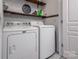 Convenient laundry room with washer, dryer, and shelving for storage at 748 Inwood Hill Dr, Gastonia, NC 28056