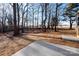 Wooded backyard with a small concrete patio at 7504 Surry Ln, Indian Trail, NC 28079