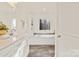 Double vanity bathroom with soaking tub and built-in shelving at 7504 Surry Ln, Indian Trail, NC 28079