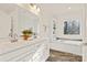 Double vanity bathroom with soaking tub and large window at 7504 Surry Ln, Indian Trail, NC 28079