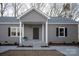 Gray house with white accents, covered porch, and black shutters at 7504 Surry Ln, Indian Trail, NC 28079