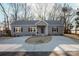 Gray house with a concrete driveway and landscaping at 7504 Surry Ln, Indian Trail, NC 28079