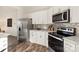 Modern kitchen with white cabinets and stainless steel appliances at 7504 Surry Ln, Indian Trail, NC 28079