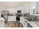 Modern kitchen with white cabinets, stainless steel appliances, and marble countertops at 7504 Surry Ln, Indian Trail, NC 28079