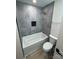 Modern bathroom with a bathtub and grey tile at 757 Bilmark Ave, Charlotte, NC 28213