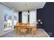 Bright dining room with wooden table and access to backyard at 8119 Merryvale Ln, Charlotte, NC 28214