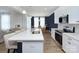 Modern kitchen with white cabinets, quartz countertops, and island at 8119 Merryvale Ln, Charlotte, NC 28214