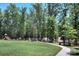 playground with swings and slide, near a lake at 8119 Merryvale Ln, Charlotte, NC 28214