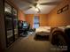 Bedroom featuring carpeted floors, ceiling fan, and large shelving unit next to the bed at 959 Avery Ct, Concord, NC 28025