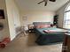 Neutral bedroom featuring carpeted floors, ceiling fan, and natural light from the arched window at 959 Avery Ct, Concord, NC 28025