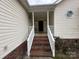 Charming covered front porch with brick steps leading to a welcoming entrance at 959 Avery Ct, Concord, NC 28025