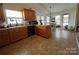 Bright kitchen featuring wood cabinets and an adjacent dining area filled with natural light at 959 Avery Ct, Concord, NC 28025