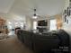 Spacious living room featuring large sectional sofa, ceiling fan and natural light at 959 Avery Ct, Concord, NC 28025