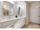 Bright bathroom featuring double sinks, white cabinetry, and neutral tile flooring at 975 Shorthill Ln, Fort Mill, SC 29715