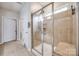 Bathroom with a glass-enclosed shower, built-in bench, and neutral tile at 975 Shorthill Ln, Fort Mill, SC 29715