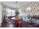 Bright dining room features wood table, globe chandelier, and fern wallpaper at 975 Shorthill Ln, Fort Mill, SC 29715