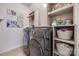 Bright laundry room with front load washer and dryer and ample shelving for storage at 975 Shorthill Ln, Fort Mill, SC 29715